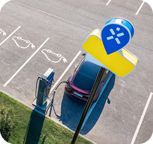 Ignitis ON įkrovimo stotelė, kurioje įsikrauna elektromobilis. Šalia matomas Ignitis ON ženklas.