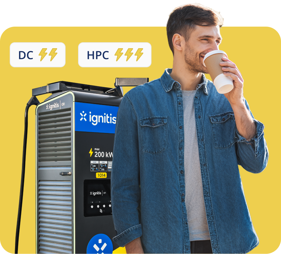 Vyras geria kavą, kol įsikrauna savo elektromobilį Ignitis ON greito įkrovimo stotelėje.